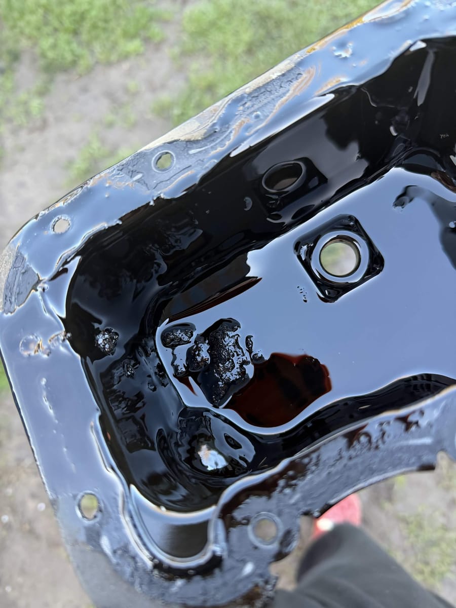 Wet belt material found in the sump from a failing timing belt